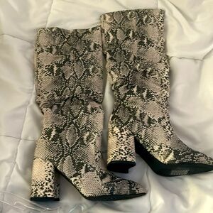 Knee high animal print boots.